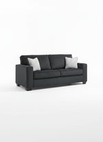Sofa-lit Marcel gris foncé par TOCO Meubles avec deux coussins décoratifs clairs sur fond blanc