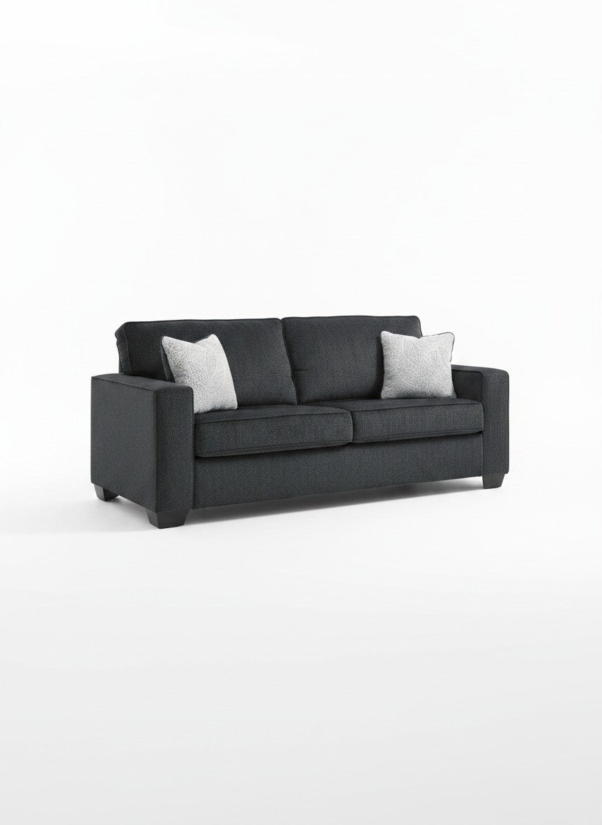 Sofa-lit Marcel gris foncé par TOCO Meubles avec deux coussins décoratifs clairs sur fond blanc