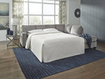 TOCO Meubles Sofa-lit sectionnel Marcel gris en tissu, transformable en lit, avec couette blanche matelassée.