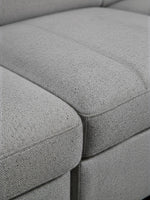 Gros plan sur le revêtement en tissu gris texturé du sofa-lit Pratiquo de TOCO Meubles