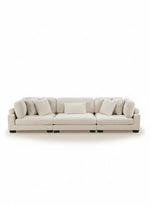 Sofa modulaire TOCO Meubles Traverse en velours côtelé beige avec coussins décoratifs sur fond blanc