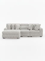 Sofa modulaire Nuage de TOCO Meubles, sectionnel gris clair texturé avec chaise longue et coussins décoratifs assortis.