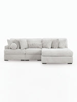 TOCO Meubles Sofa Modulaire Nuage gris clair en tissu texturé avec coussins assortis et un coussin rond.