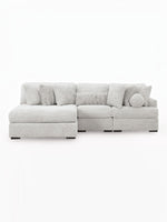 TOCO Meubles Sofa modulaire Nuage gris clair en tissu texturé, avec chaise longue et coussins assortis.