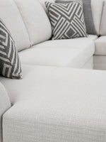 Sofa sectionnel TOCO Meubles Koralynn en tissu beige texturé avec coussins décoratifs à motifs géométriques gris