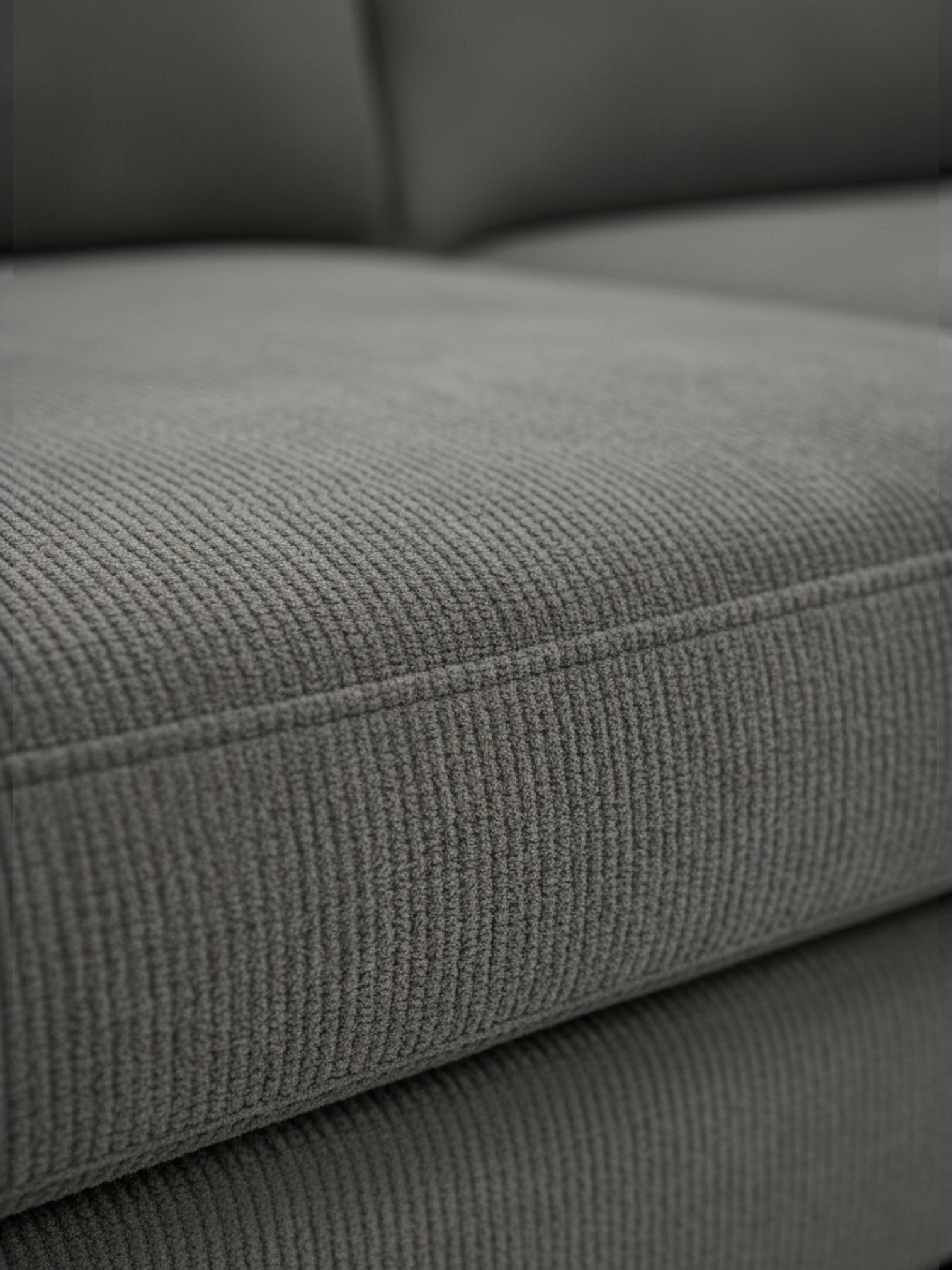 Gros plan sur le tissu texturé gris du sofa sectionnel Neo de TOCO Meubles