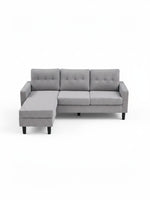 Sofa sectionnel réversible Malo gris par TOCO Meubles avec coussins capitonnés et pieds noirs