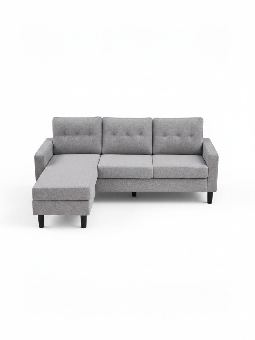 Sofa sectionnel réversible Malo gris par TOCO Meubles avec coussins capitonnés et pieds noirs