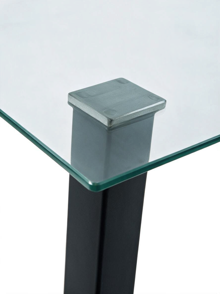 Détail du coin de la table TOCO Meubles Ranco avec plateau en verre trempé et pied en métal noir