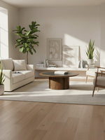 Table de salon ronde Donta par TOCO Meubles avec plateau noir et base cylindrique en bois massif dans un salon moderne