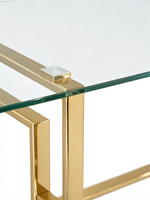 Détail de la table de salle à manger TOCO Meubles Teros avec plateau en verre trempé et structure en or poli