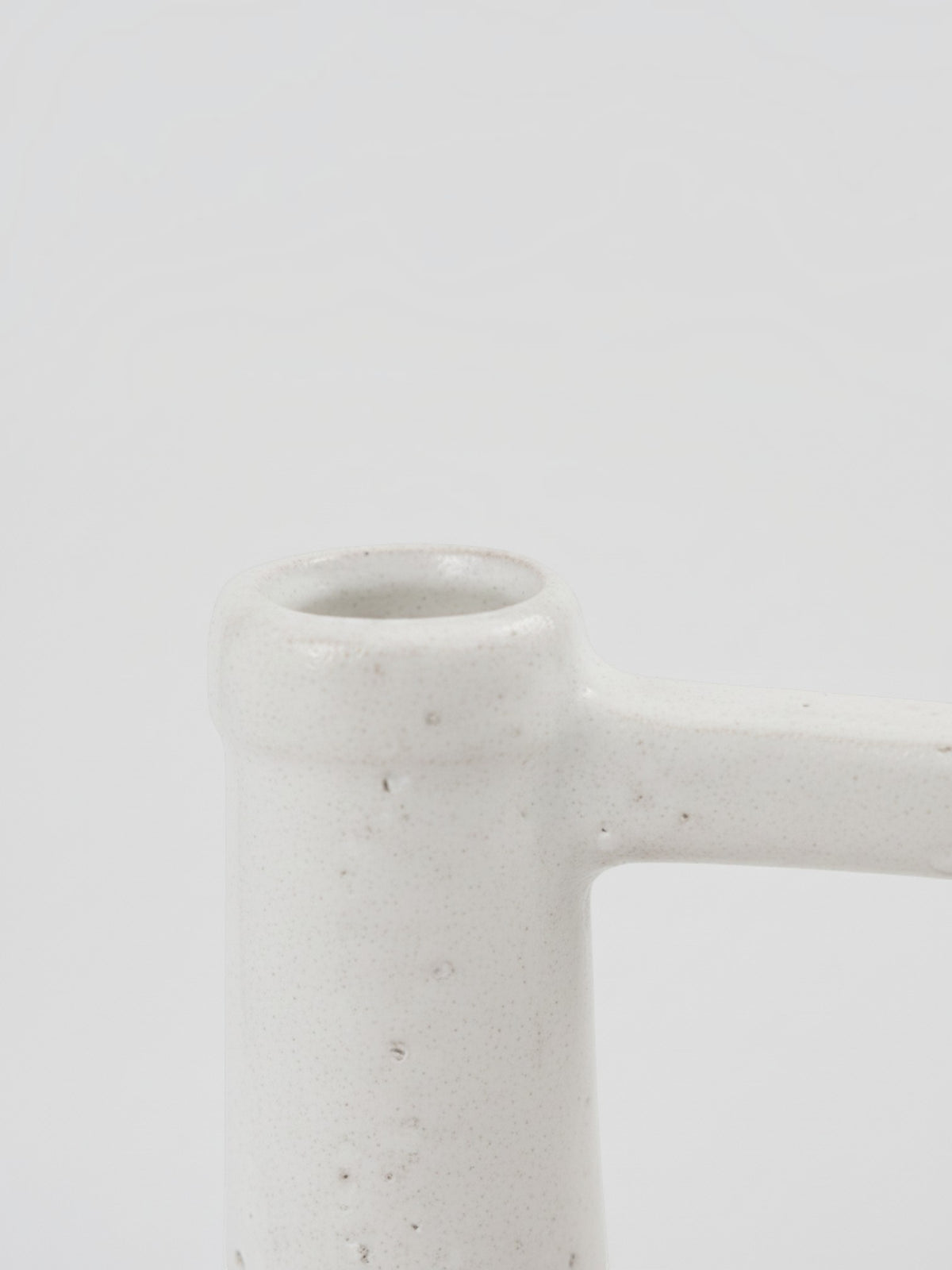 Gros plan sur le col et l'anse du vase en céramique blanche texturée Burton de la marque TOCO Meubles