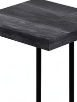 TOCO Meubles Eliott industrial C-shaped side table with dark wood effect top and black metal legs.
