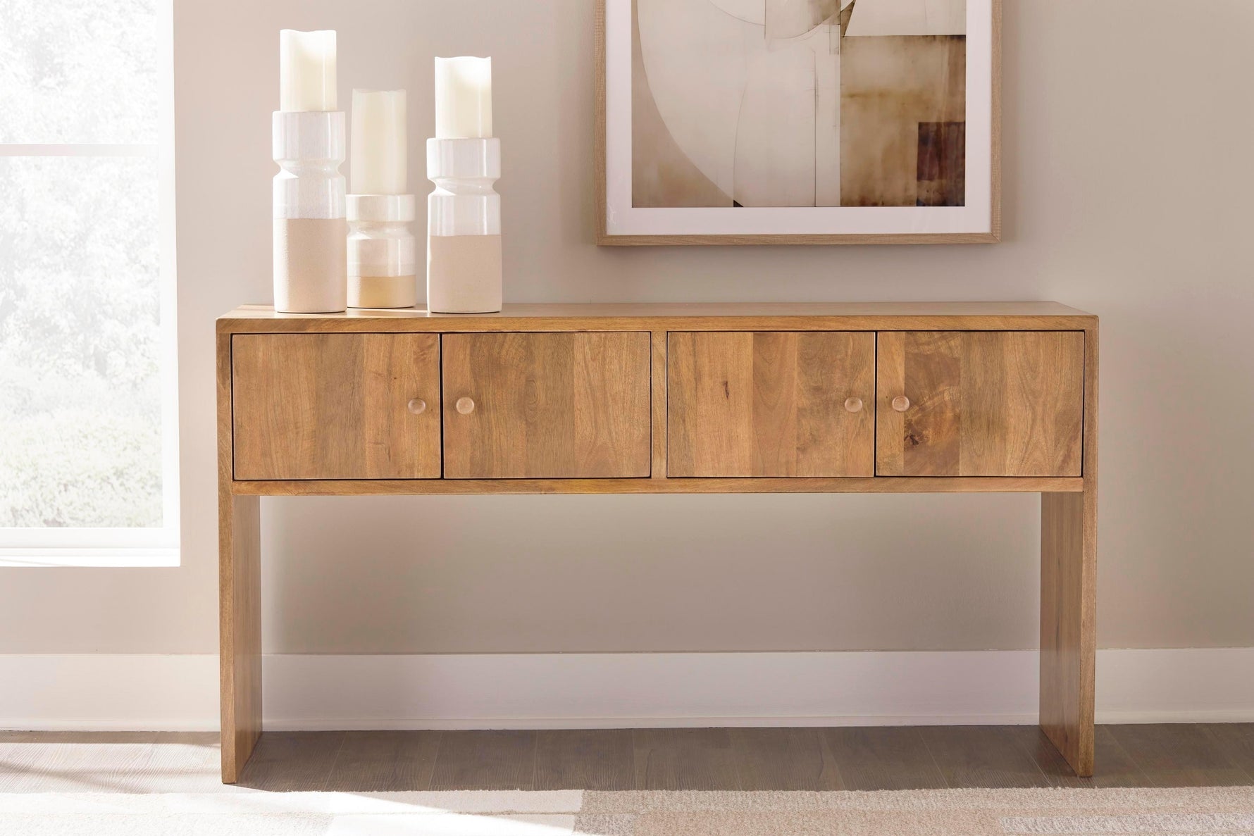 TOCO Meubles Kelani console table in natural wood finish with four cabinet doors and round wooden knobs.
